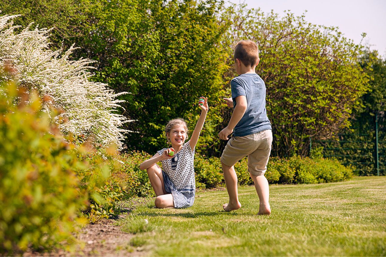Zwei spielende Kinder im Garten