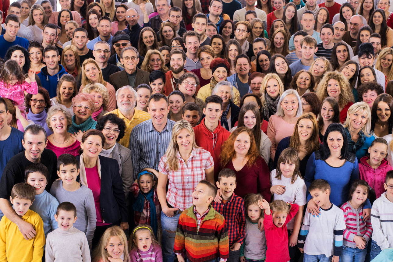 Crowd of happy people standing together and looking at camera.