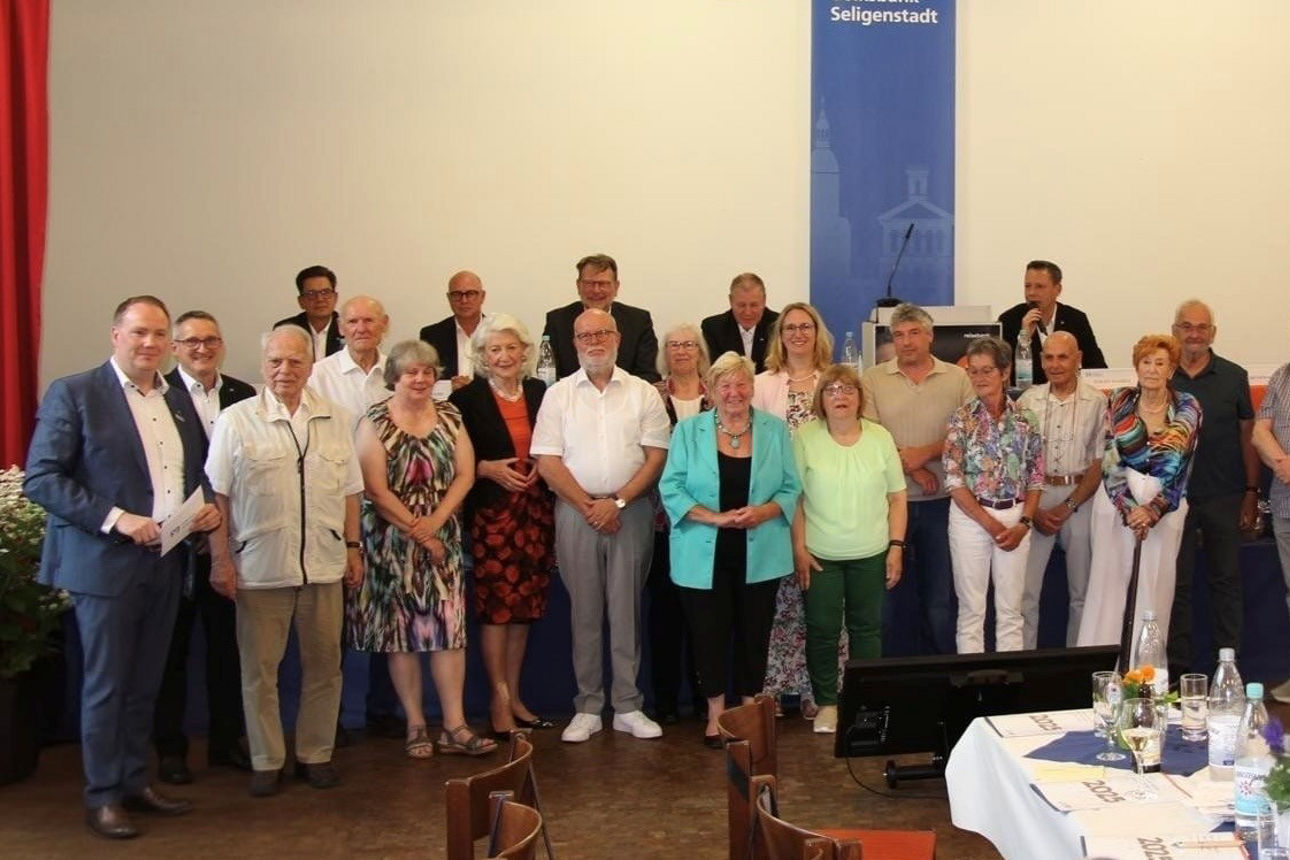 Eine Gruppe von Menschen versammelte sich zu einer Veranstaltung bei der Volksbank Seligenstadt.