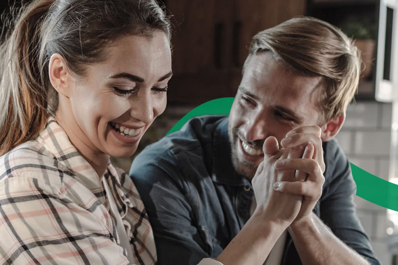 Ein Paar sitzt lächelnd zusammen