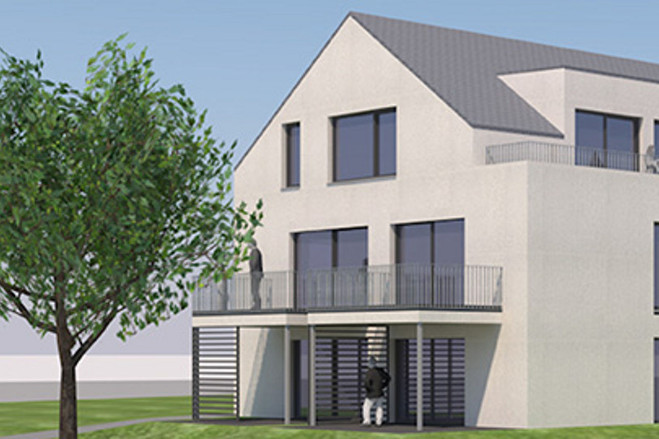 Modell eines Neubau Mehrfamilienhauses mit Spitzdach und Balkonen. Rechts die Aufschrift "Wohnen in Aitrach".