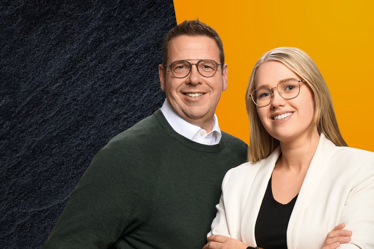 Kollegen stehen neben einander vor schwarz und orangenem Hintergrund