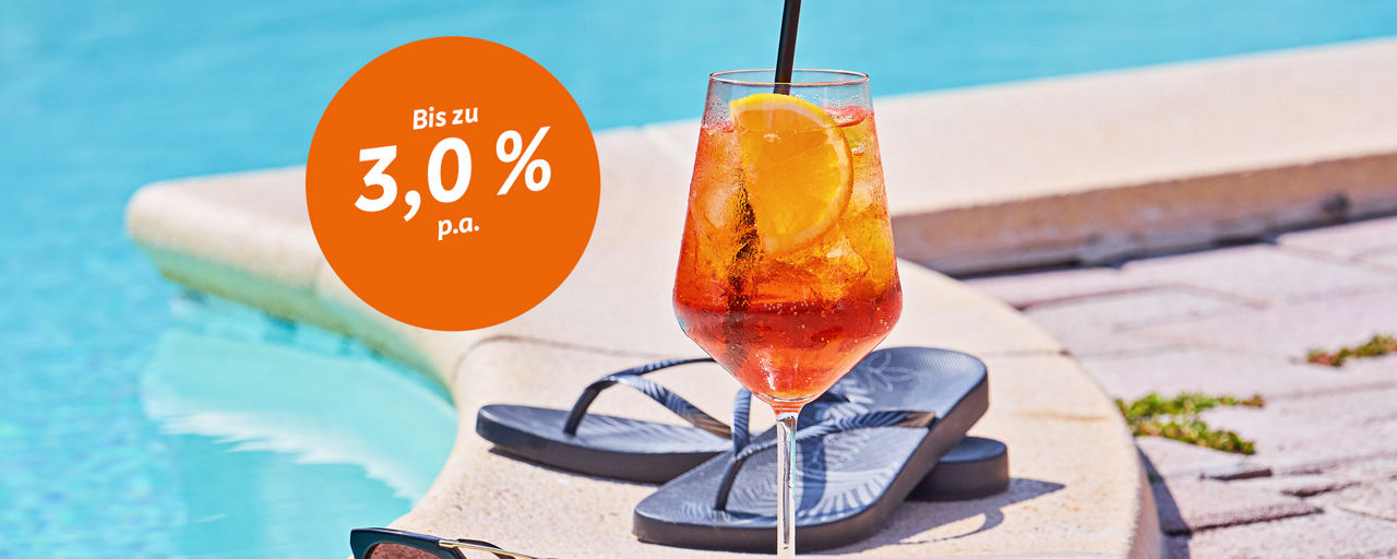 Ein Cocktailglas steht auf dem Rand eines Pools