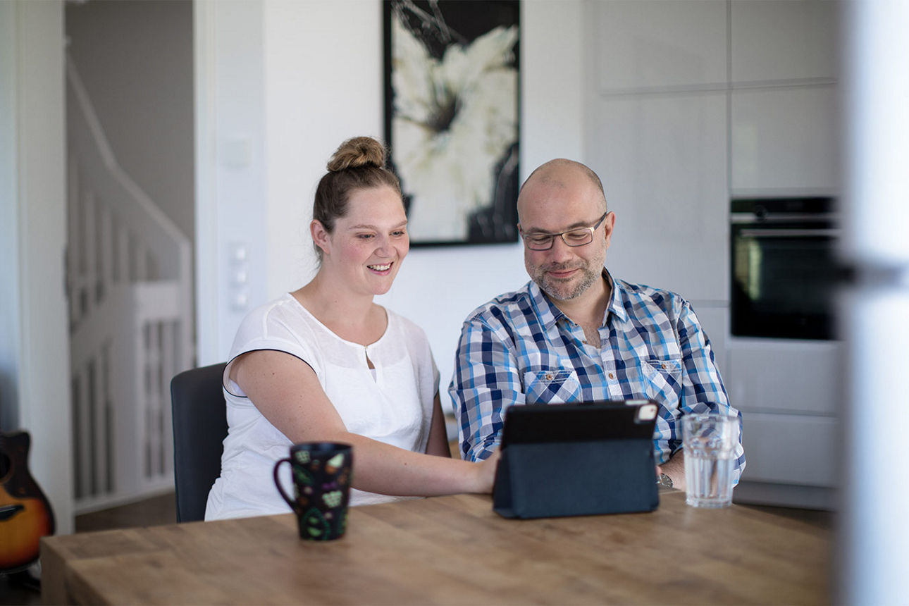 Junge Frau mit Brille zeigt zwei Daumen hoch und freut sich über das Festgeld