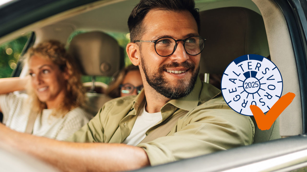 Ein junges Paar sitzt zusammen im Auto. Auf der Rücksitzbank ist noch die Tochter zu erkennen