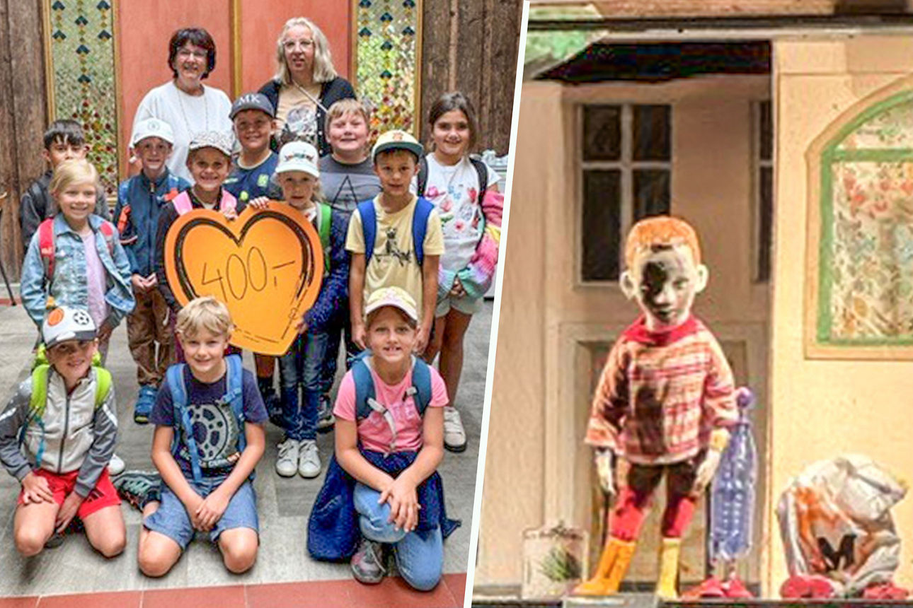 Eine Gruppe von Schulkindern und ihre erwachsenen Begleitpersonen, die ein herzförmiges Schild hochhalten 