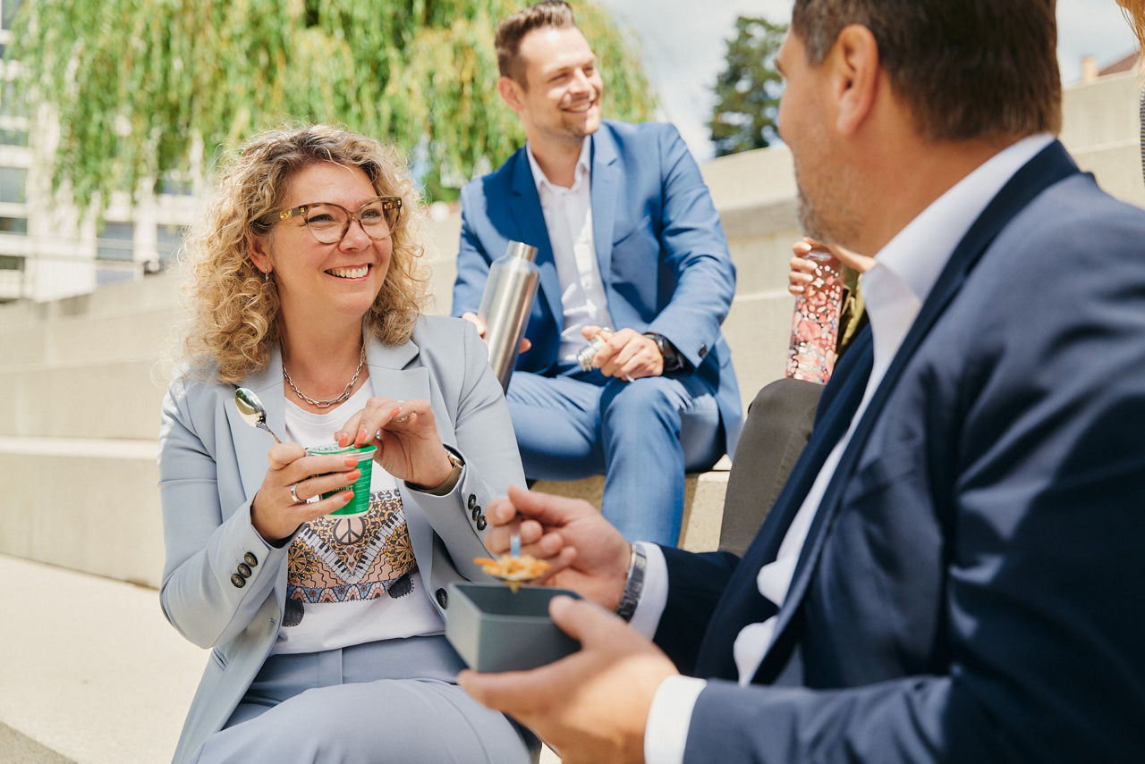 Lächelnde Mitarbeitende in der Pause