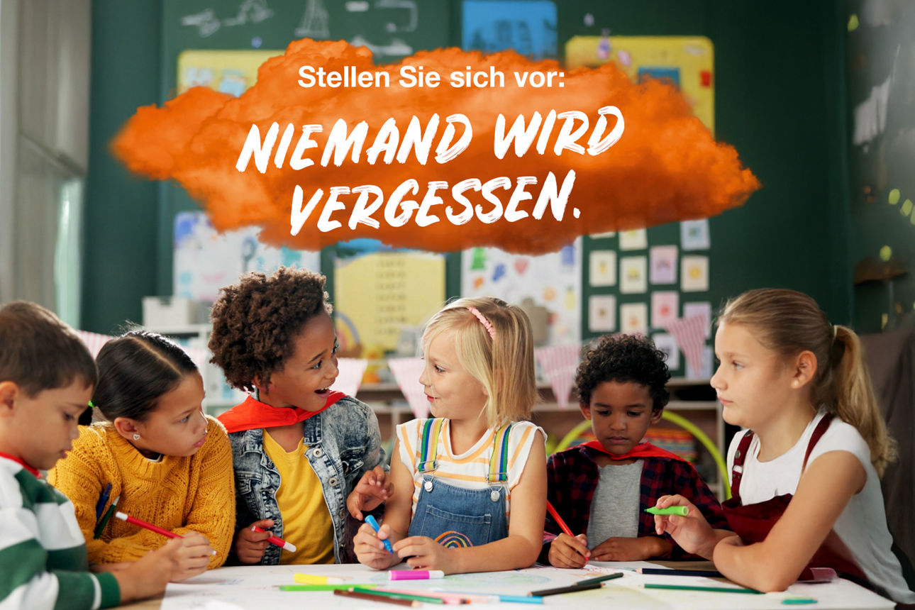 Sechs Kindergarten-Kinder sitzen an einem Tisch unterhalten sich und malen