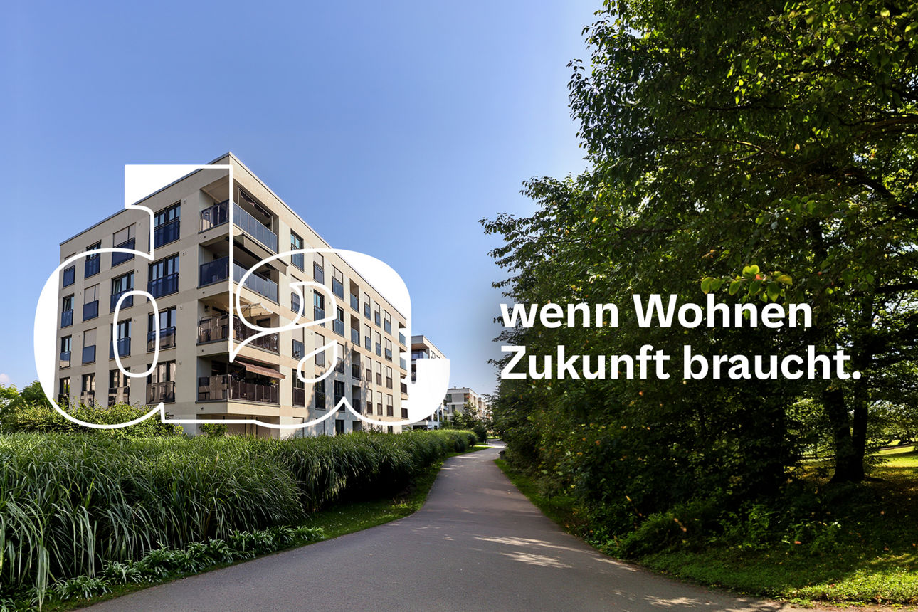 Anblick auf genossenschaftliche Wohnungen mit Bäumen im Vordergrund.