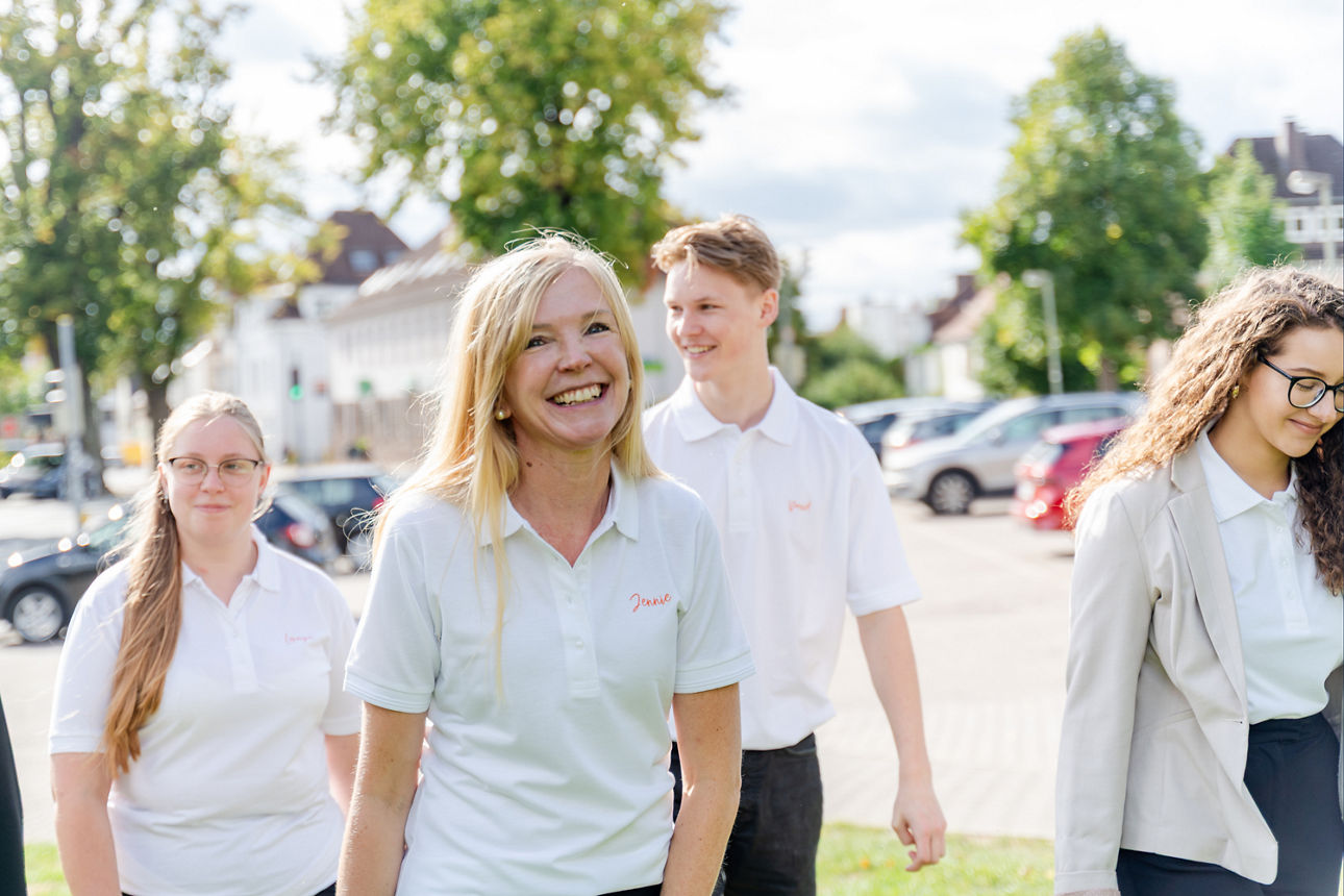 Azubis in weißer Kleidung, die sich draußen befinden
