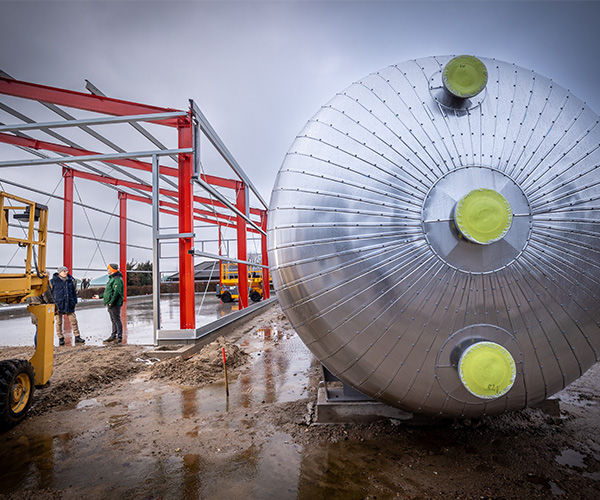Silberne Pufferspeicher, in dem die Abwärme der Biogasanlage Wasser erhitzt