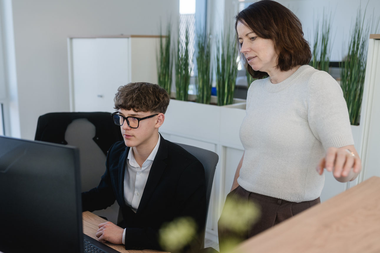 zwei Personen im Büro vor einem Monitor