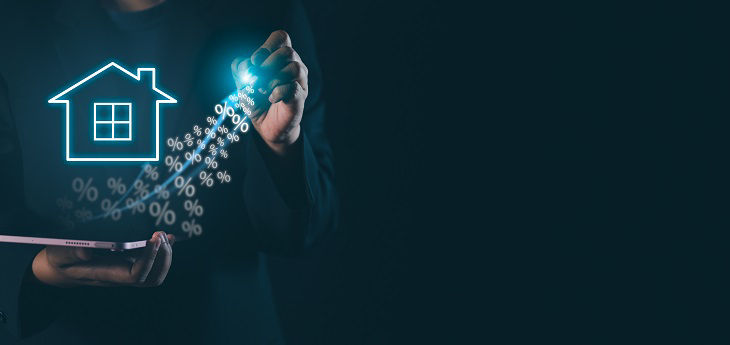 Grafik leuchtendes Haus mit Prozentzeichen vor dunklem Hintergrund