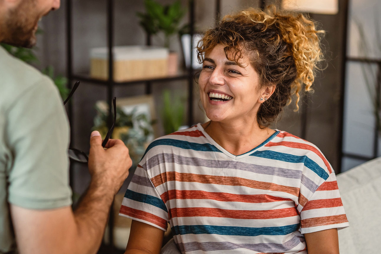 girlfriend sit on sofa read book and discuss about that whit her boyfriend