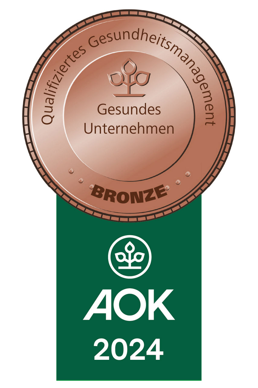 Eine Bronzemedaille mit der Aufschrift „Qualifiziertes Gesundheitsmanagement“ und „Gesundes Unternehmen“.