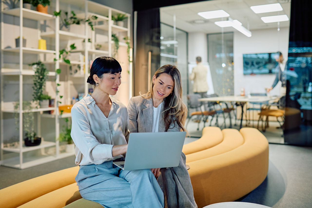 Businesswomen collaborating on laptop during office meeting