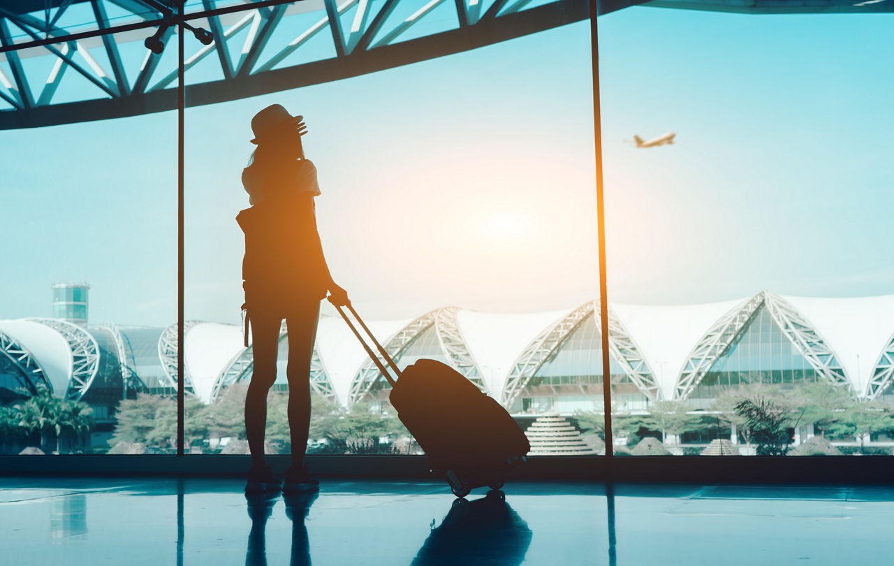Silhouette woman travel with luggage looking without window at airport terminal international or girl teenager traveling in vacation summer relaxation holding suitcase and backpack