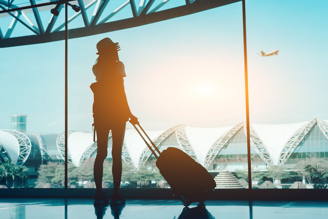 Silhouette woman travel with luggage looking without window at airport terminal international or girl teenager traveling in vacation summer relaxation holding suitcase and backpack