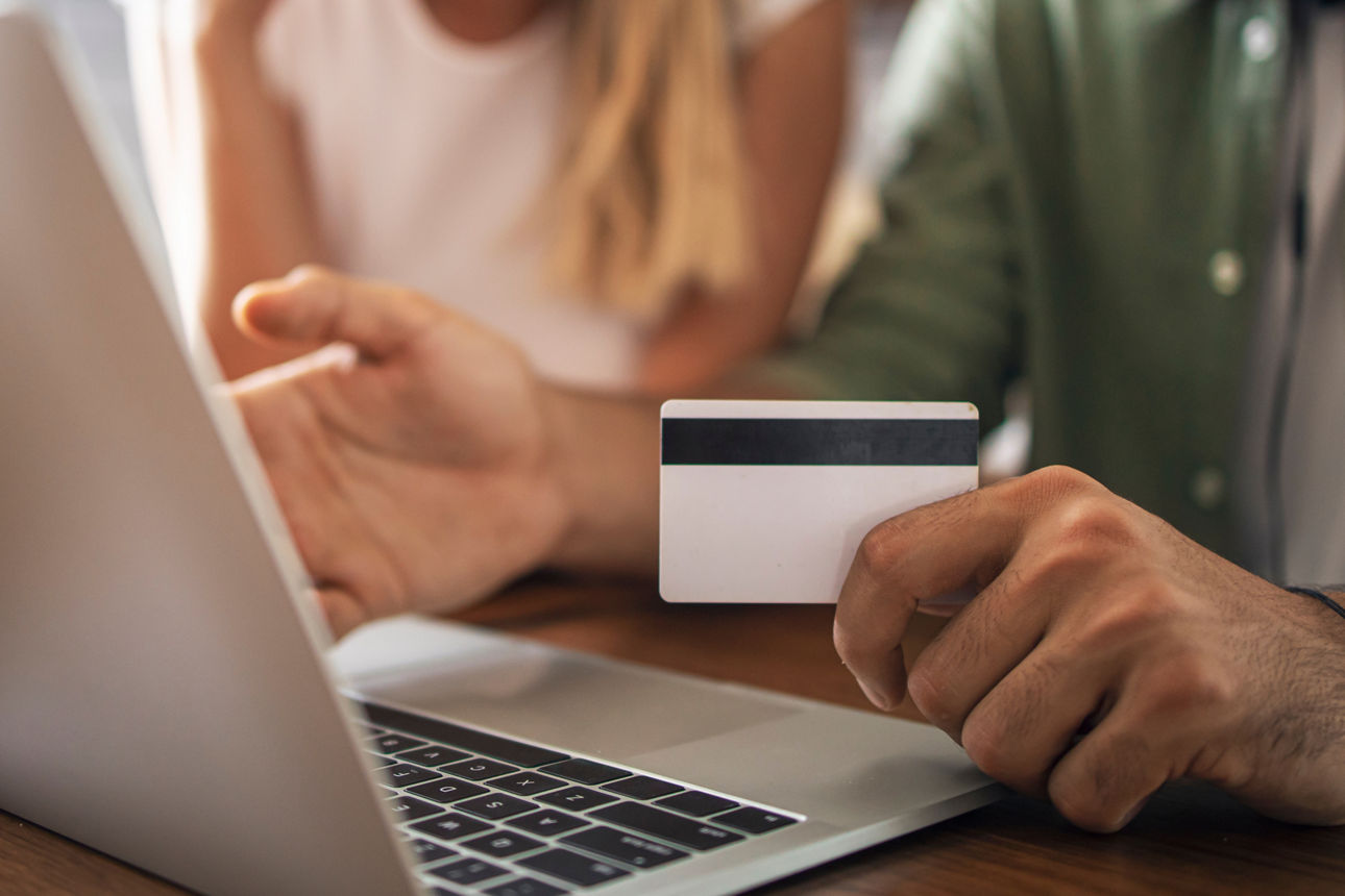 A happy entrepreneur using smart phone while working online at her home office.