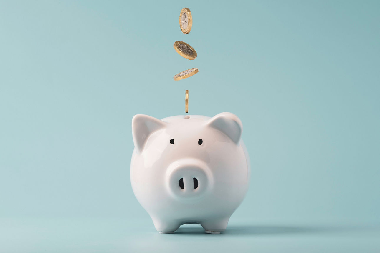 Coins falling to white piggy saving ,  Financial and money deposit concept.