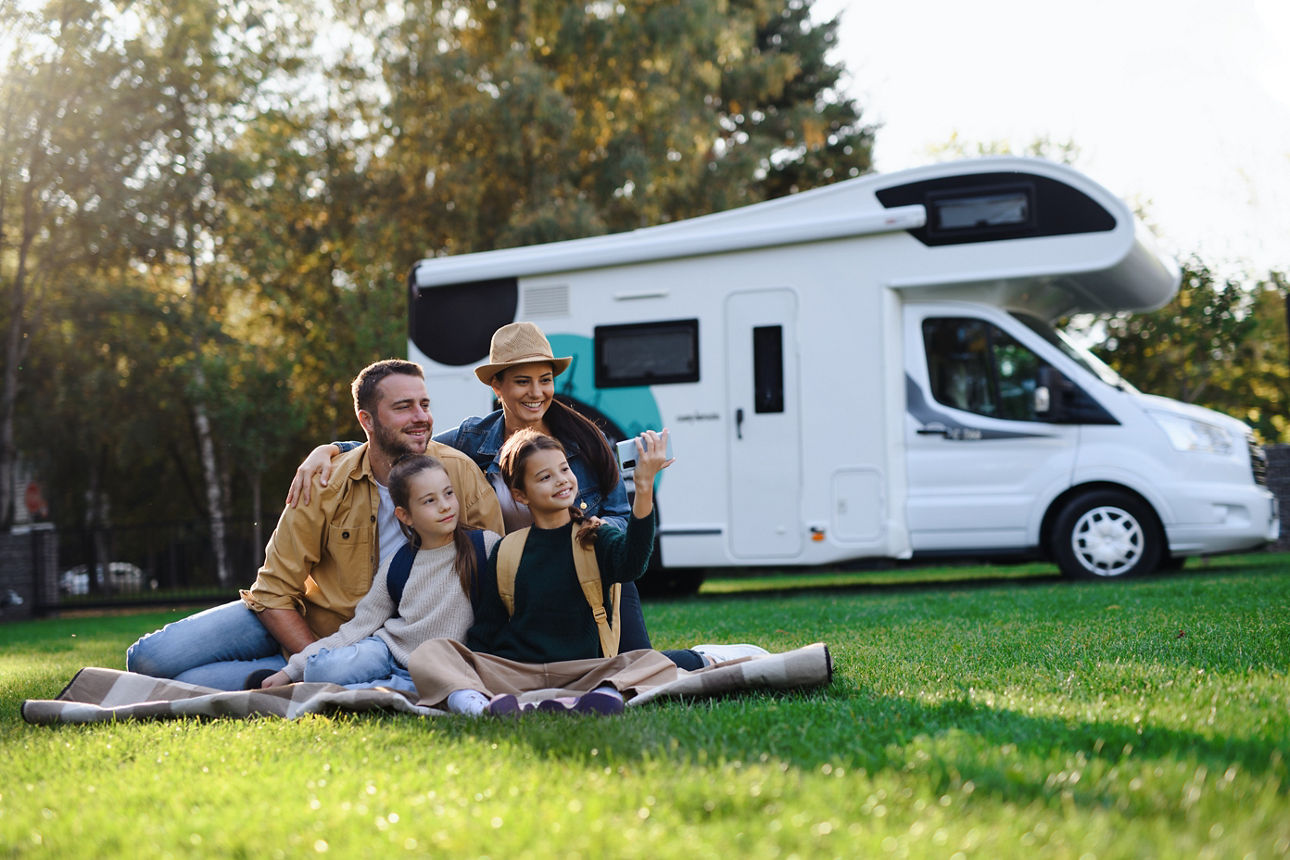 joyful familiy relaxing in the porch of thier motorhome 