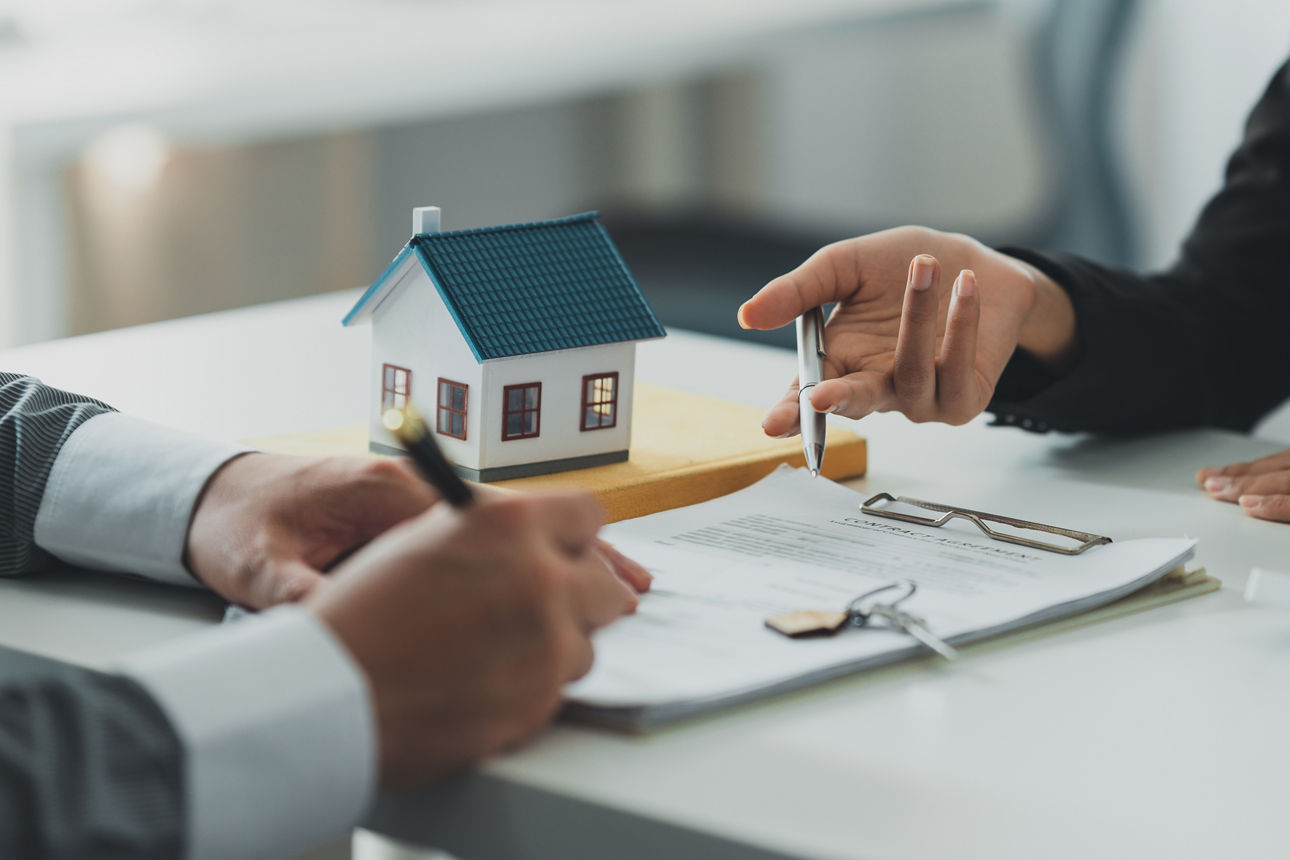 Close up Business woman or Real Estate agent explain signing agreement for buying house. Bank manager and real estate concept