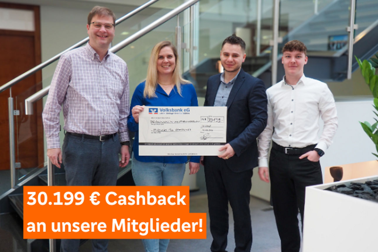 R+V Kollegen halten Scheck hoch mit Cashback-Summe