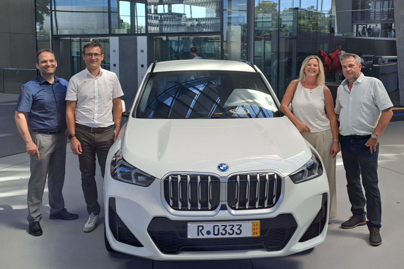 Der Gewinner zusammen mit seiner Frau und dem Autogewinn, einem BMW X1.