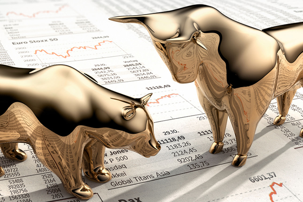 Goldene Symbolfiguren auf Finanzzeitung