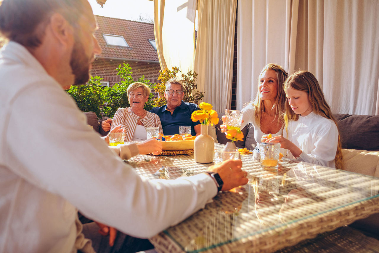 Mehrgenerationen einer Familie sitzen zusammen am Tisch