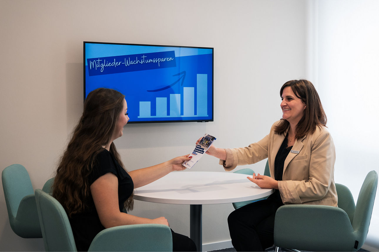Eine Kundin mit ihrer Beraterin vor einem Bildschirm