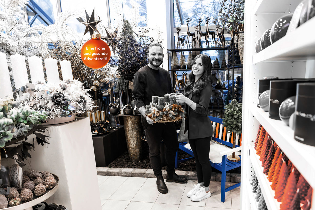 Eine junge Frau und ein Mann stehen zusammen in einem Blumengeschäft