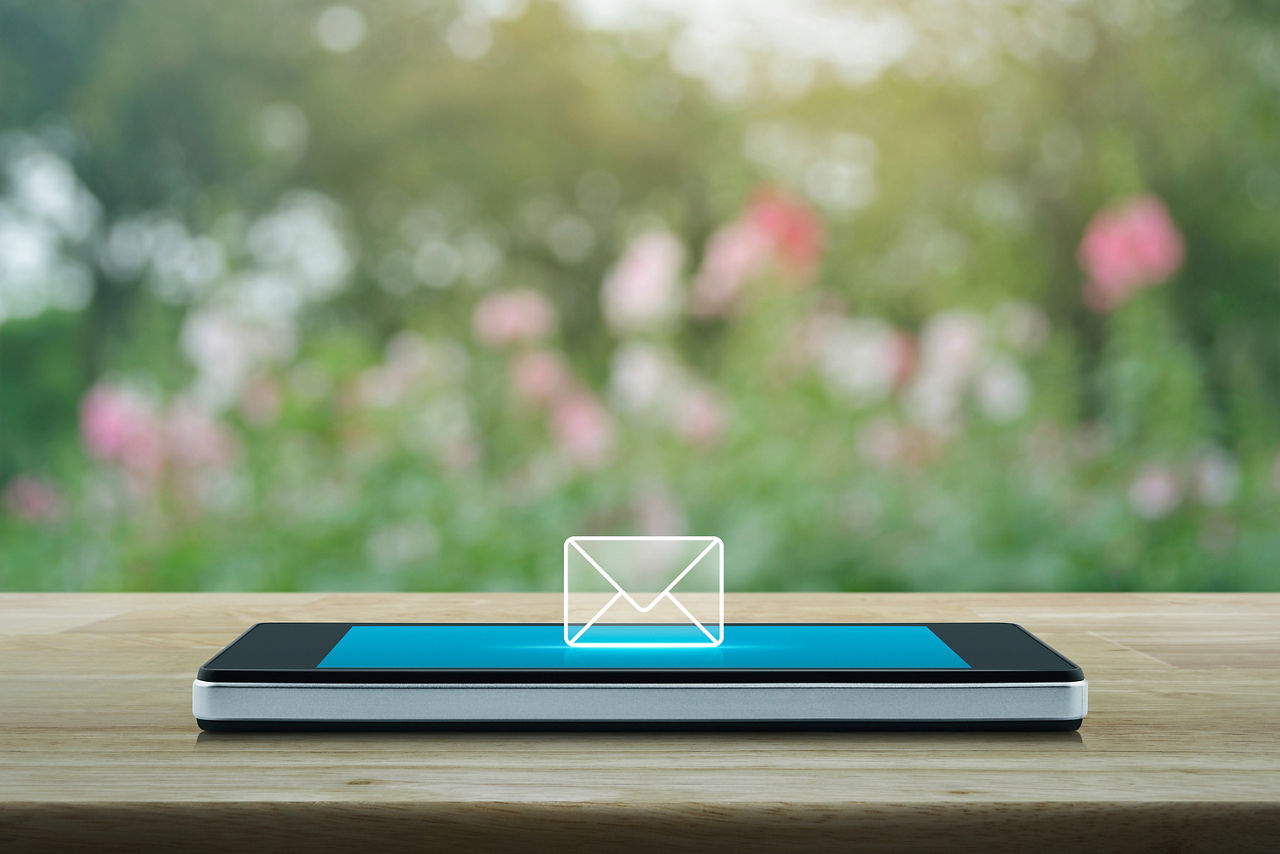 Smartphone liegt auf dem Tisch mit Brief-Icon
