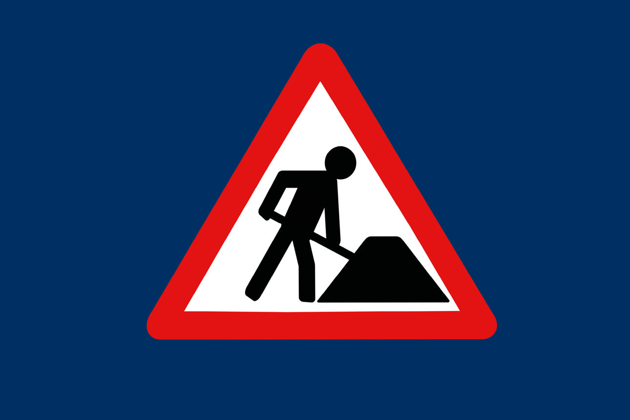 Baustellenschild auf dunkelblauem Hintergrund.