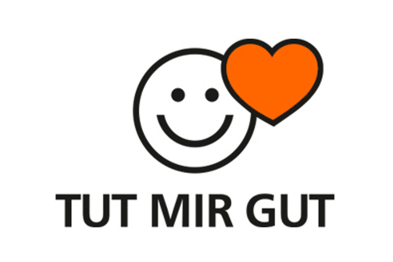 Ein lächelnder Smiley mit rotem Herz und dem Schriftzug: Tut mir gut