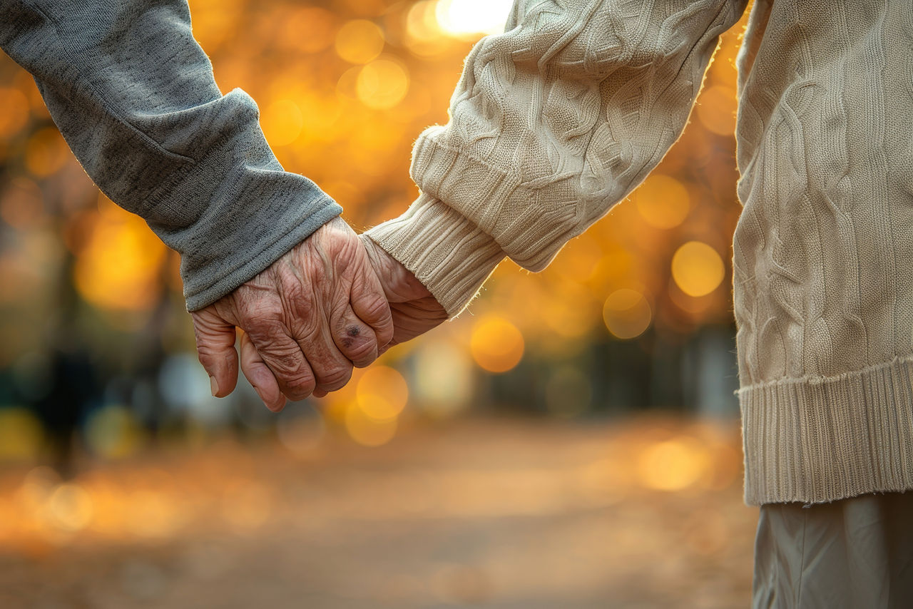 Nahaufnahme der Hände eines älteren Paares, die Hand in Hand gehen. KI genriert