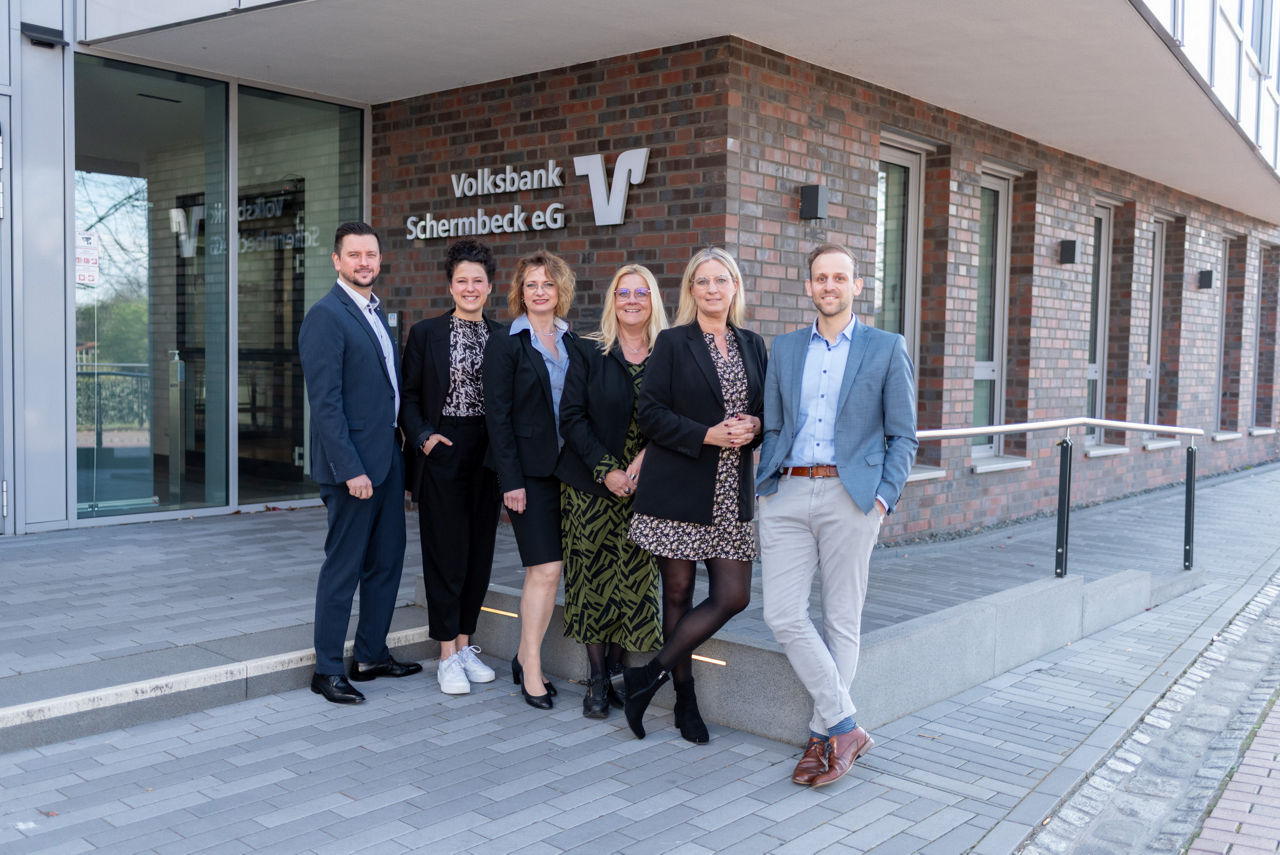 Eine Gruppe von Personen stehend vor der Bank
