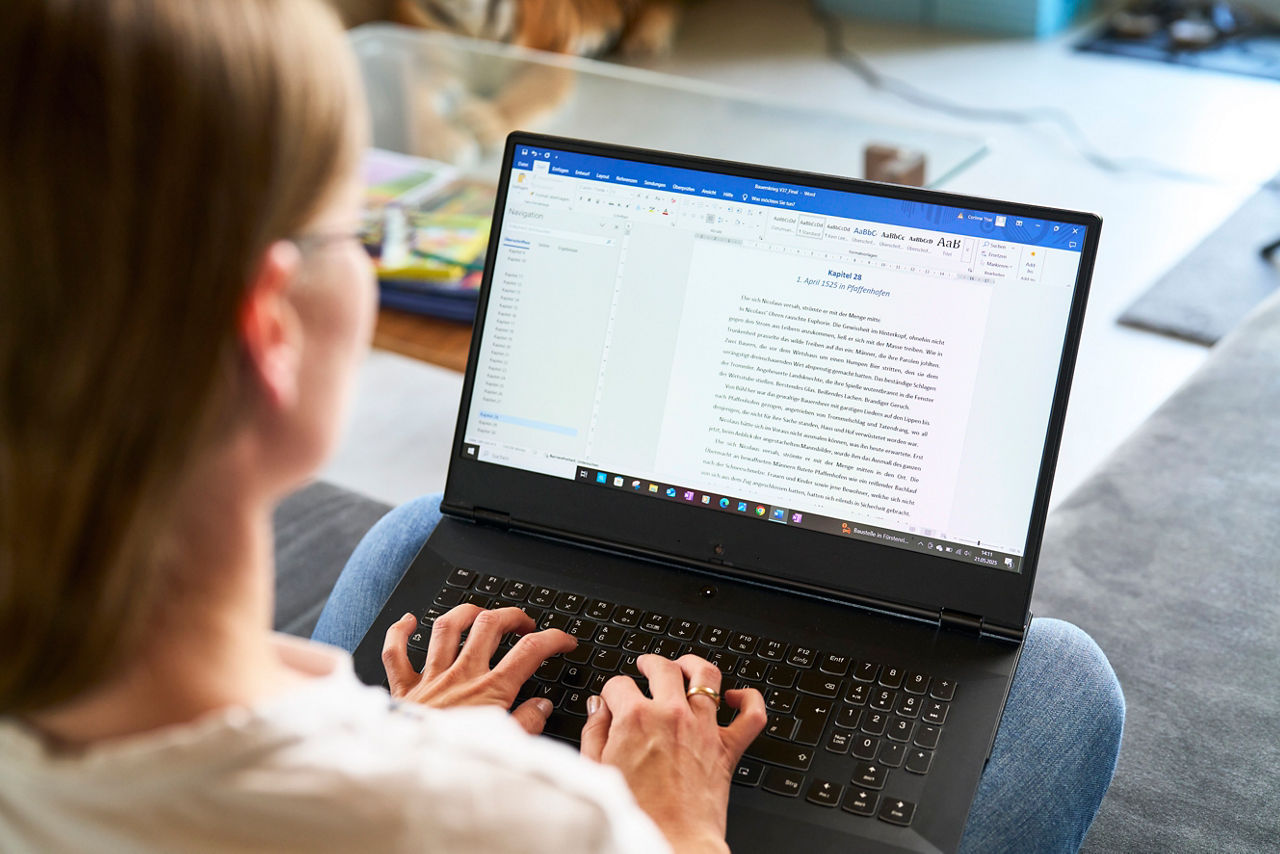 Corinna Seidler an einem Laptop auf dem Sofa
