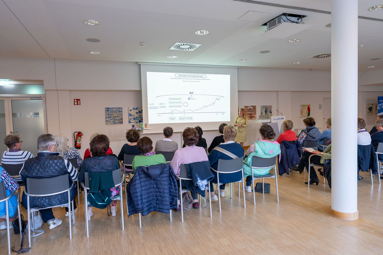Eine Gruppe von Frauen sitzt in der Volksbank und lauscht einem Vortrag