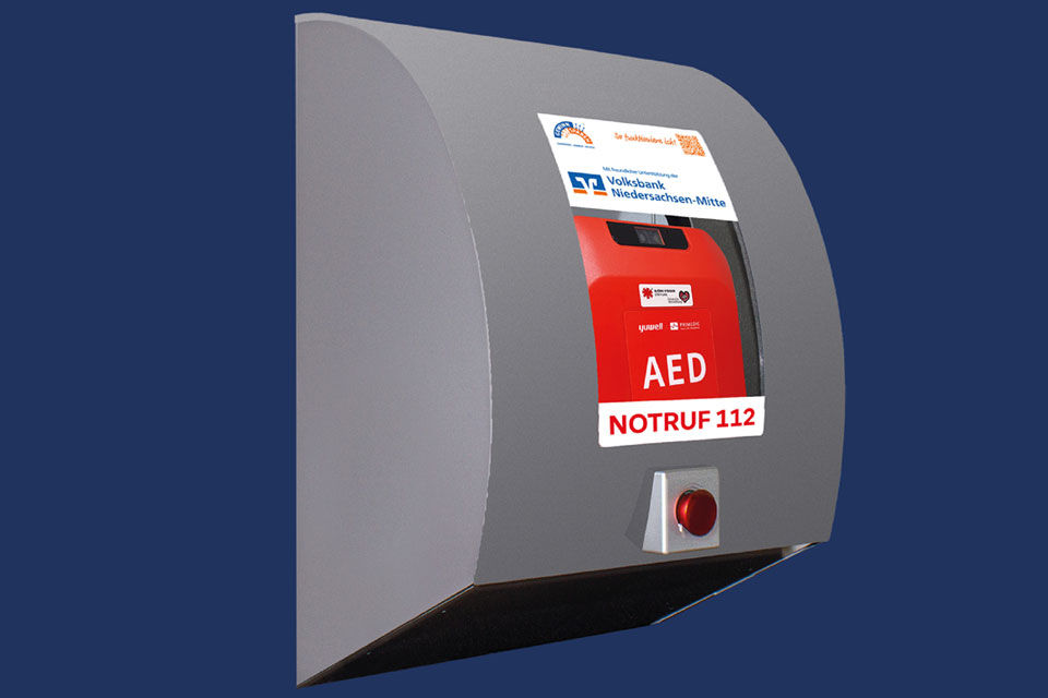 Symbolische Darstellung eines Defibrillators mit der Aufschrift Volksbank Niedersachsen-Mitte
