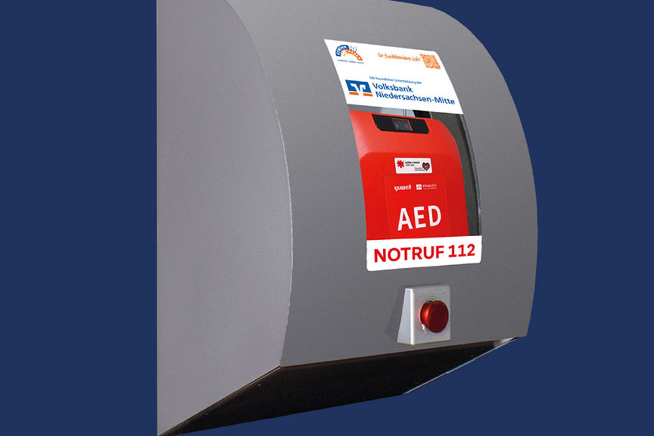 Symbolische Darstellung eines Defibrillators mit der Aufschrift Volksbank Niedersachsen-Mitte