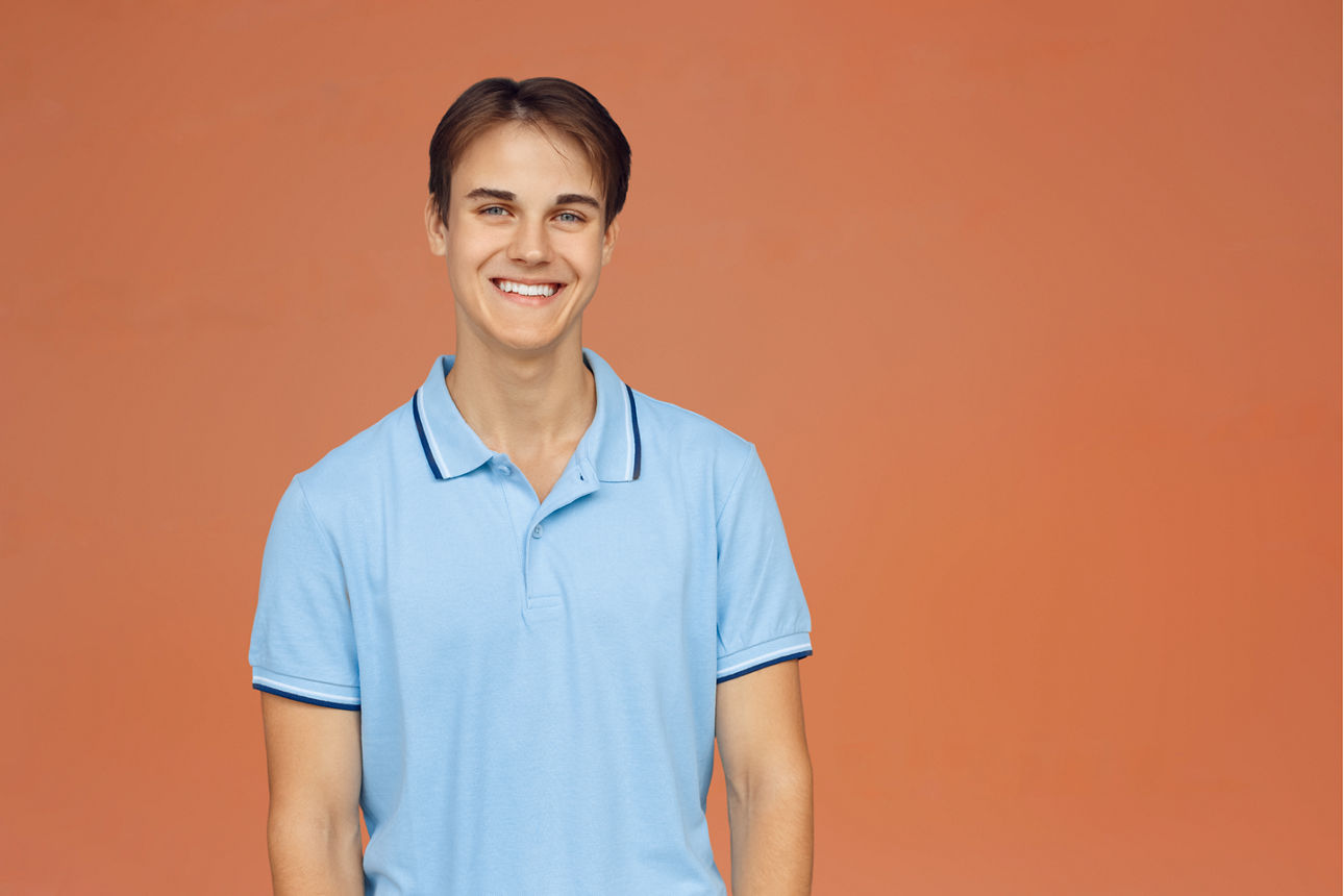 Extremely happy girl high school female pupil student teenager with backpack holding books copybooks winning gesture celebrating having success standing isolated on blue background copy space
