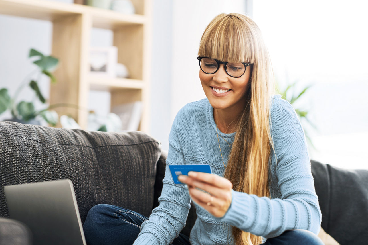 Frau hält eine Mastercard DirectCard in der Hand