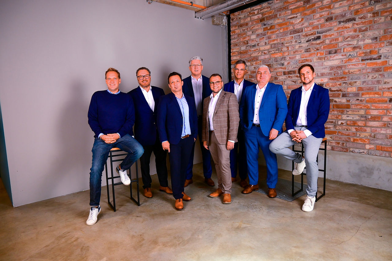 Eine Gruppe Menschen steht vor einer Wand