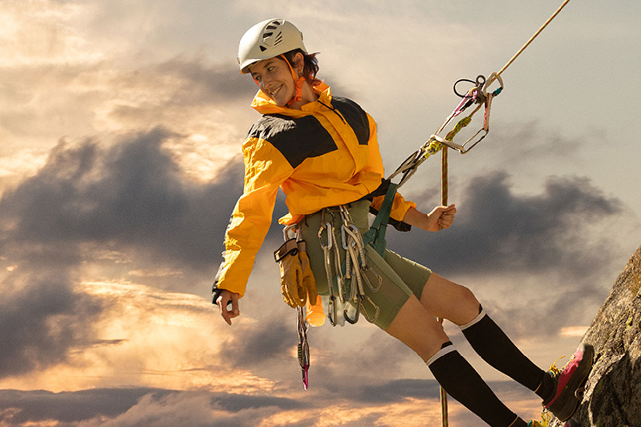 Eine Frau seilt sich von einem Berg ab