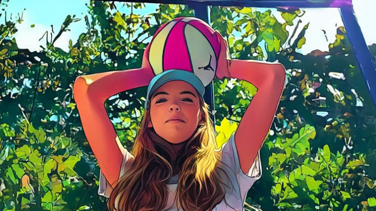 Mädchen hält einen Ball über ihren Kopf