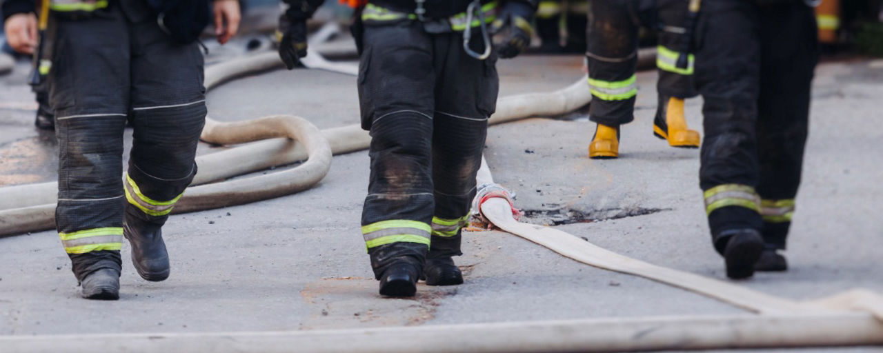 Drei Feuerwehrleute gehen auf den Fotografen zu