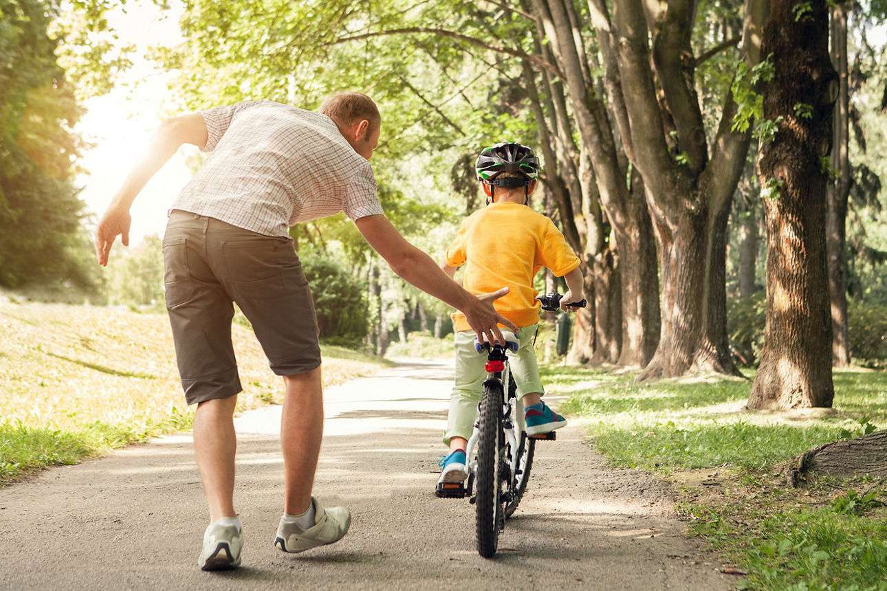 Vater zeigt seinem Sohn das Fahrradfahren