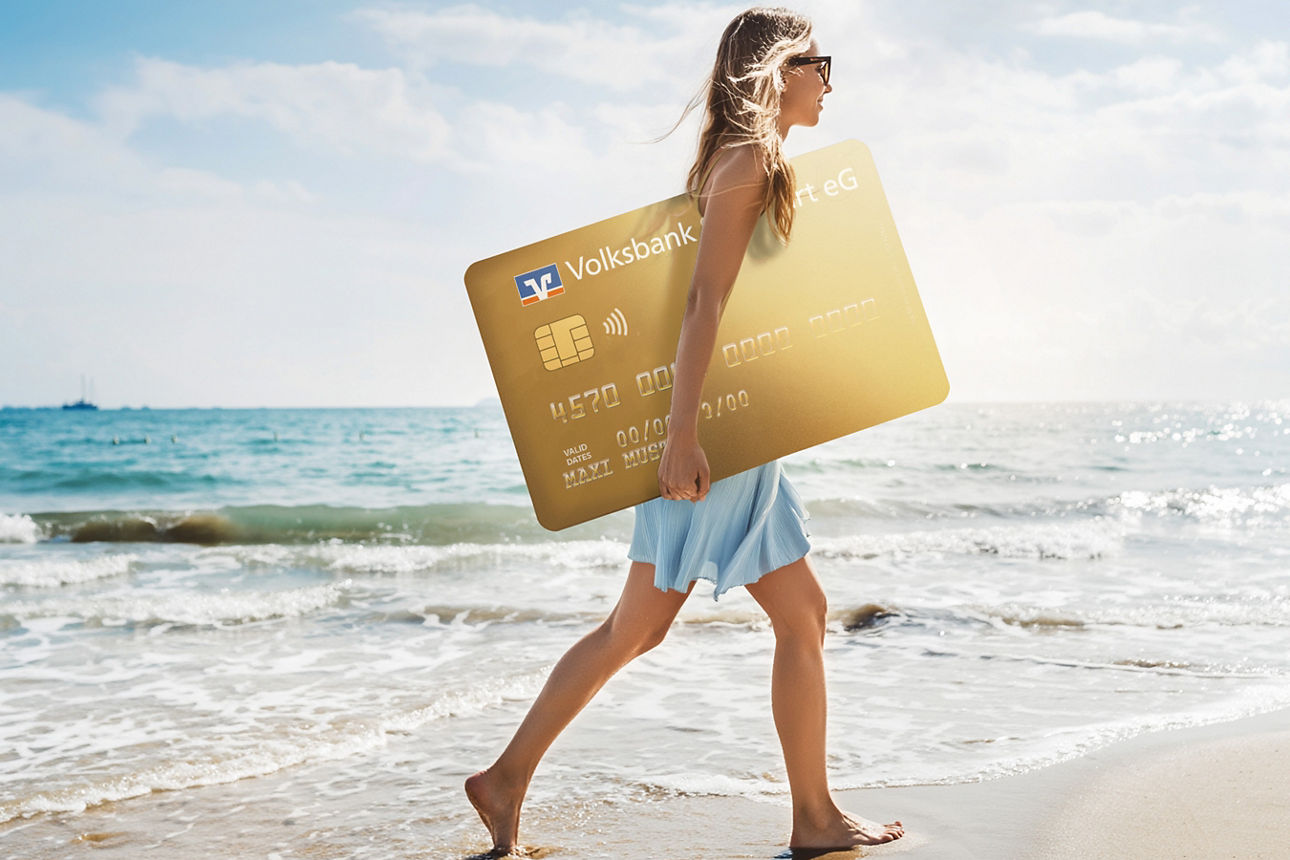 Frau mit goldener Kreditkarte läuft am Strand