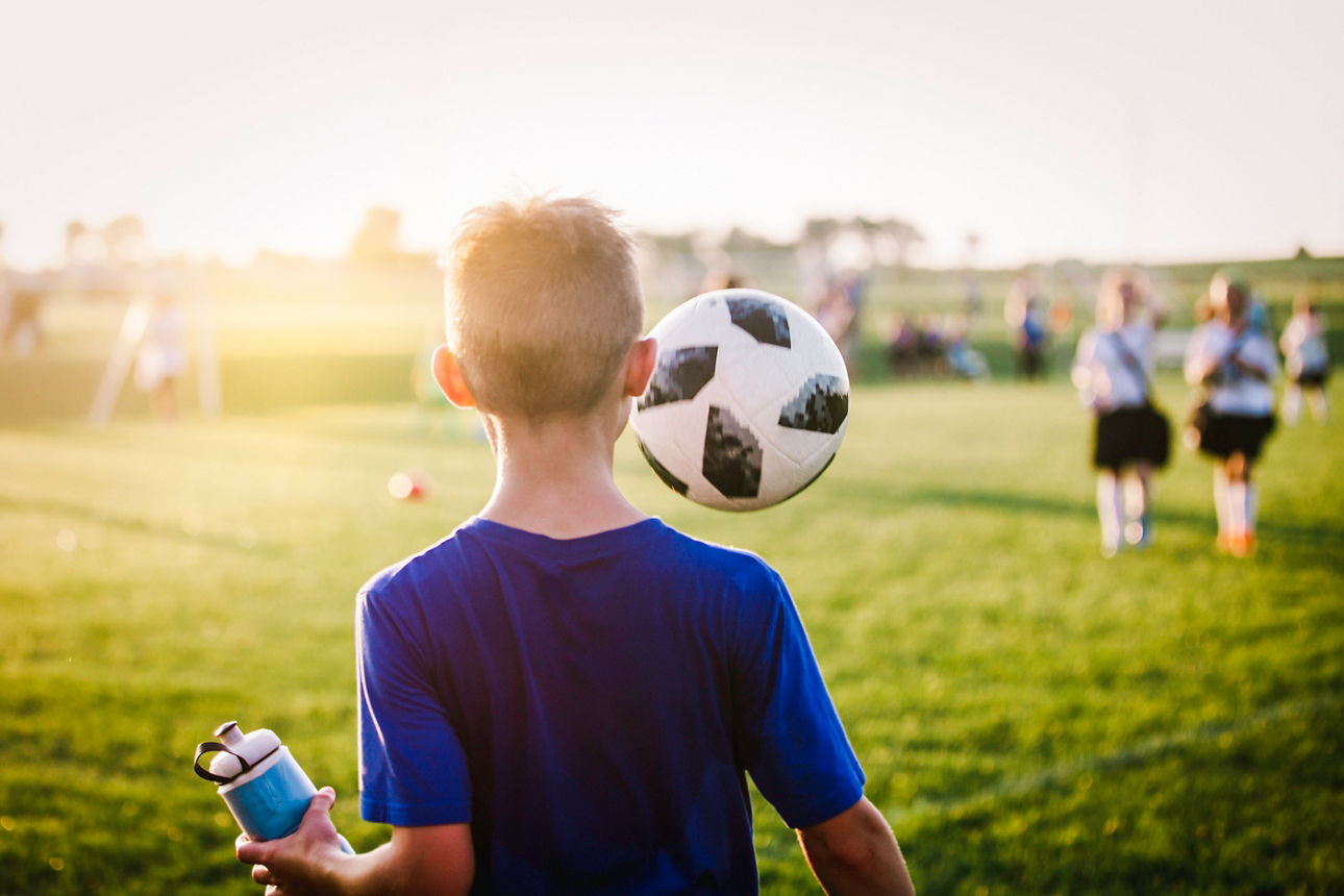 Junge spielt Fußball.